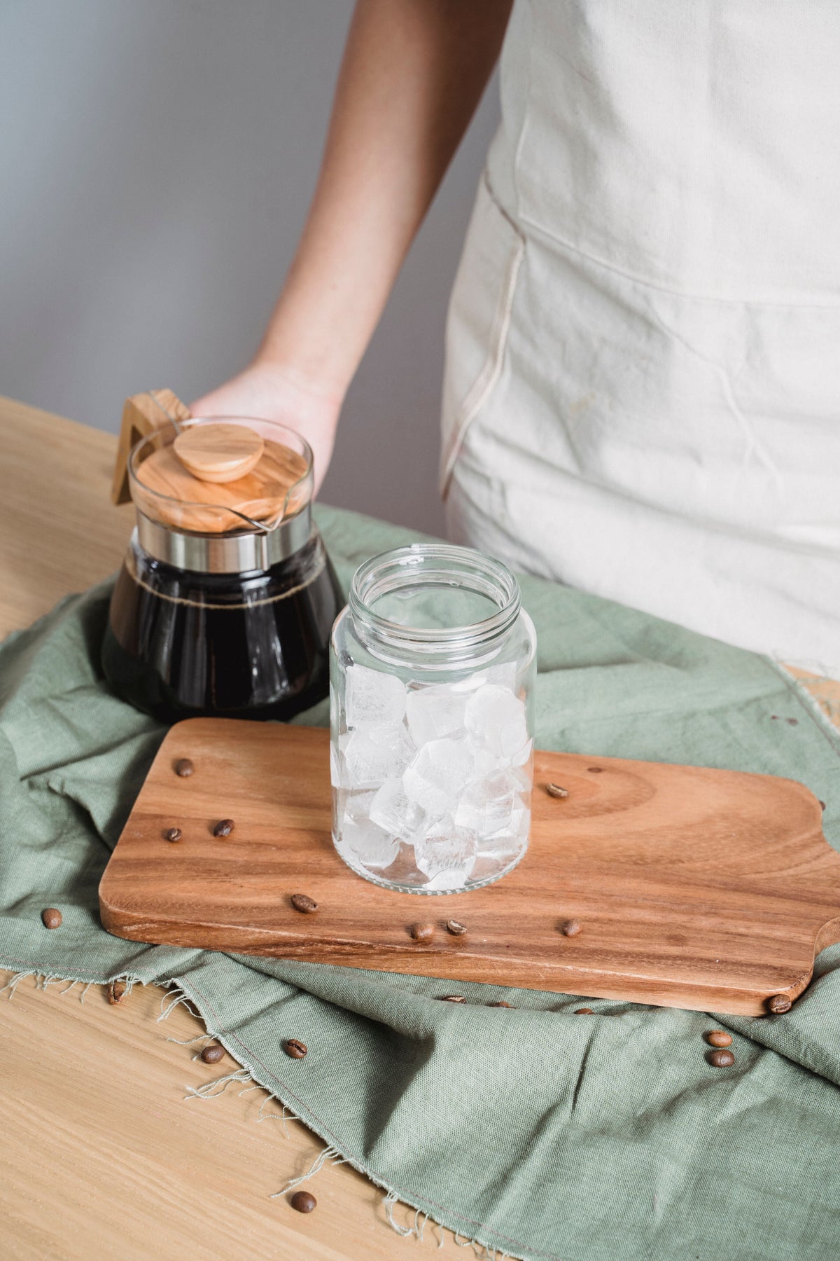 Dark coffee beside a glass jar filled with ice cubes