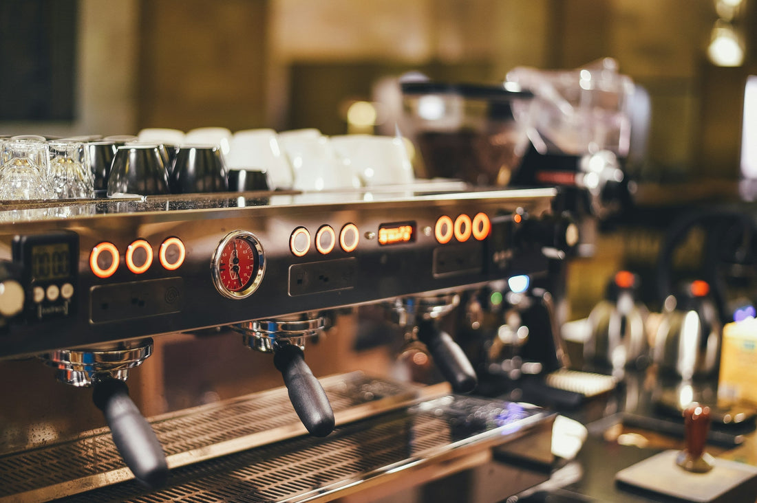 Commercial espresso machine with portafilters locked into the group heads